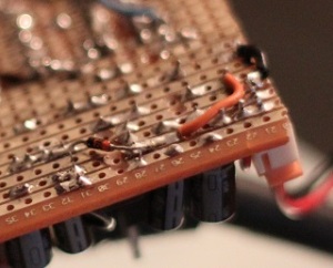 Picture of a Stripboard showing solder side with components in place